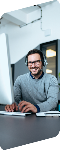 man at a computer typing on keyboard
